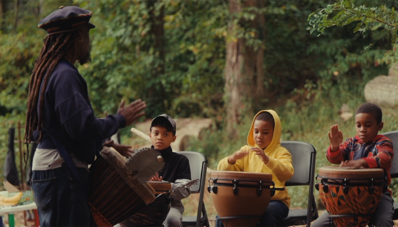 Teacher & Students playing drums in the woods