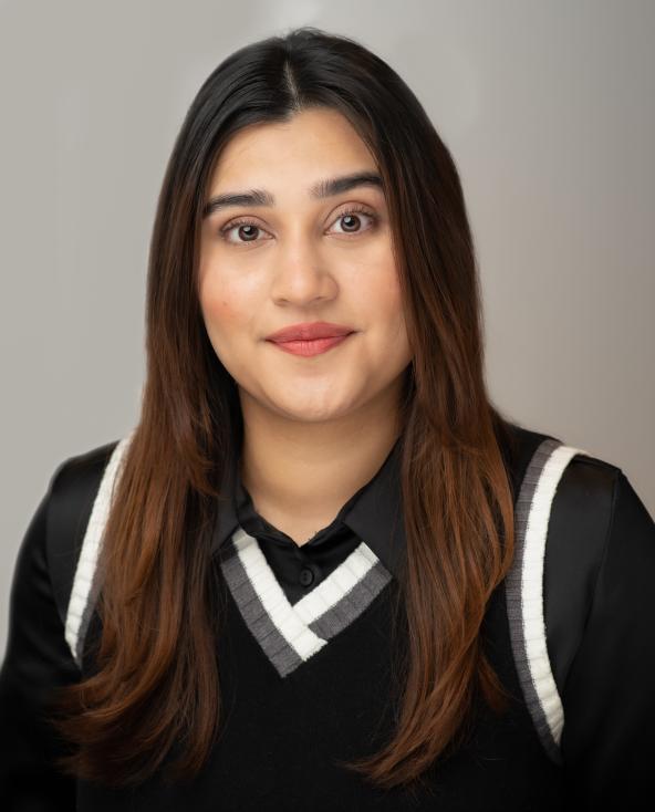Dania Headshot. She's wearing a black sweater vest
