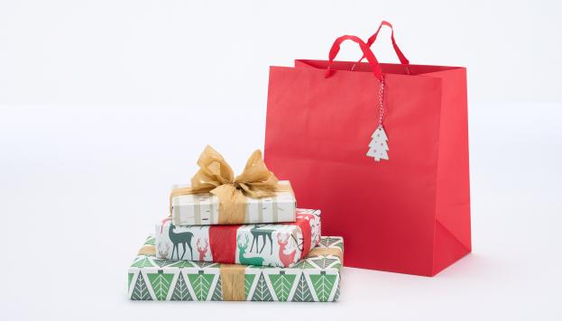 Pile of wrapped gifts and red gift bag