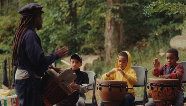 Teacher &amp; Students playing drums in the woods
